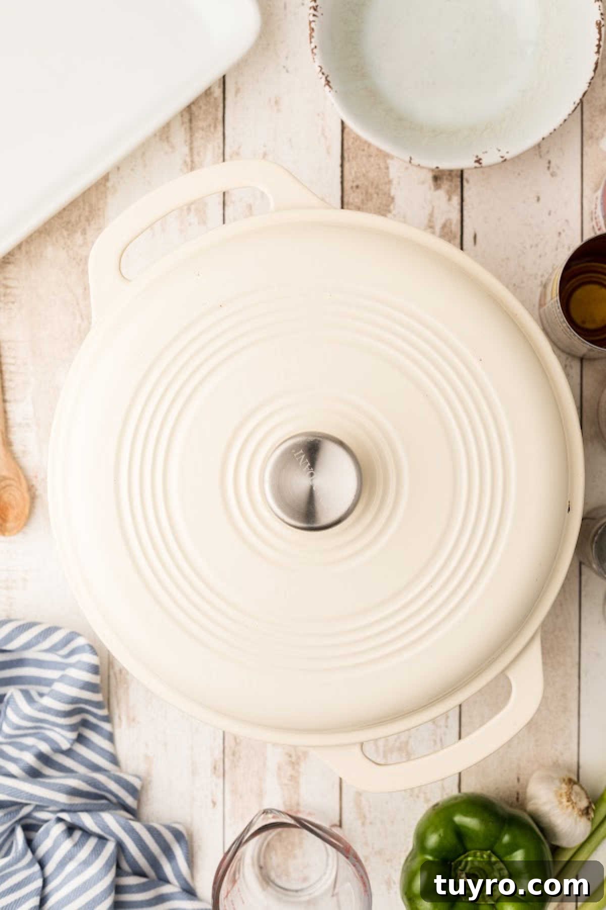 A lid closing a Dutch oven pot cooking a Pastalaya recipe.