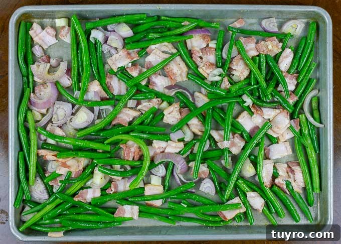 Crisp Roasted Green Beans with Bacon and Caramelized Shallots 4 raw Fresh Roasted Green Beans with Bacon and Shallots on metal baking sheet