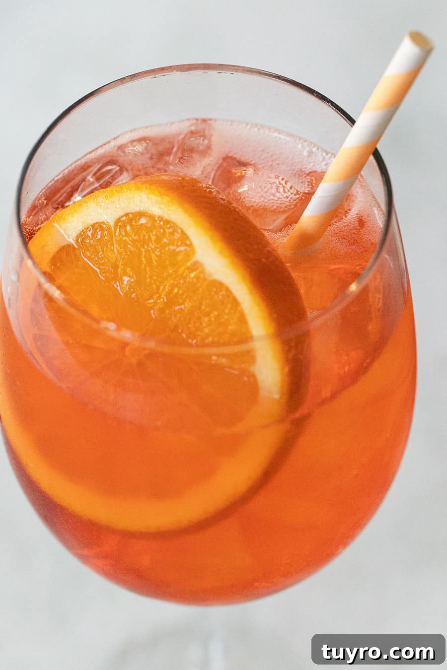 3-Ingredient Aperol Spritz Recipe for Summer Cocktails 2 Classic Aperol Spritz cocktail with orange slice in wine glass over ice.