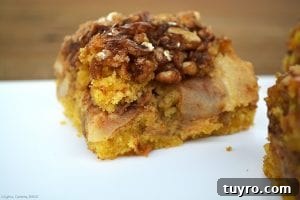 Maple Apple Walnut Slice Recipe: Moist Autumn Cake 3 Close up of the Maple Apple and Walnut Slice. An almost apple cake like base that is light, fluffy and buttery with a rich and sweet walnut and oat crumble and a liberal amount of maple syrup poured over top to marry all the elements together.