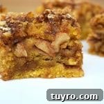 Maple Apple Walnut Slice Recipe: Moist Autumn Cake 6 Close up of the Maple Apple and Walnut Slice. An almost apple cake like base that is light, fluffy and buttery with a rich and sweet walnut and oat crumble and a liberal amount of maple syrup poured over top to marry all the elements together.
