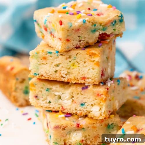 Birthday Cake Blondies Recipe with Sprinkles and Frosting 14 four birthday cake blondies stacked on top of each other