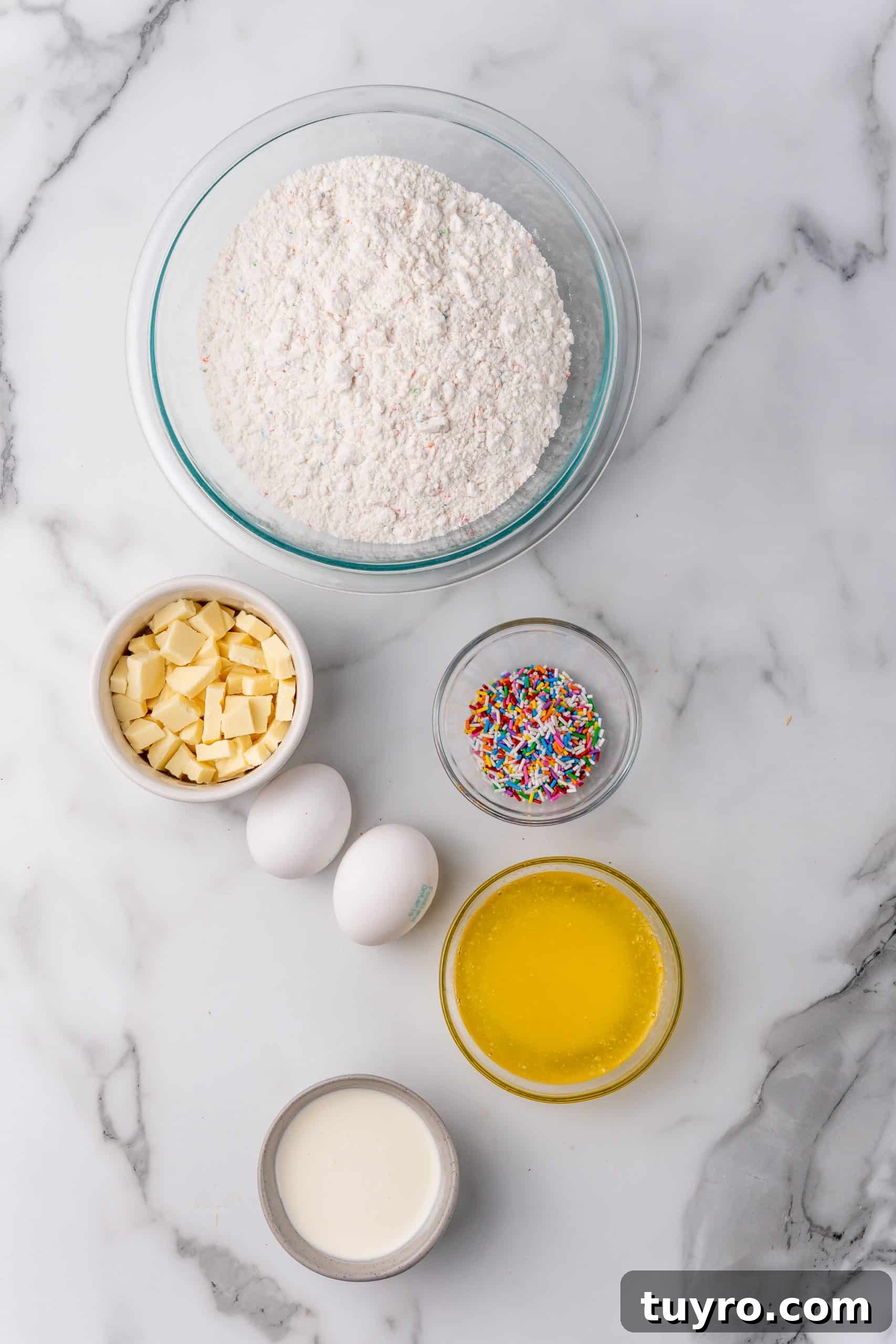 Birthday Cake Blondies Recipe with Sprinkles and Frosting 4 overhead image showing the measured ingredients needed to make a batch of cake batter blondies