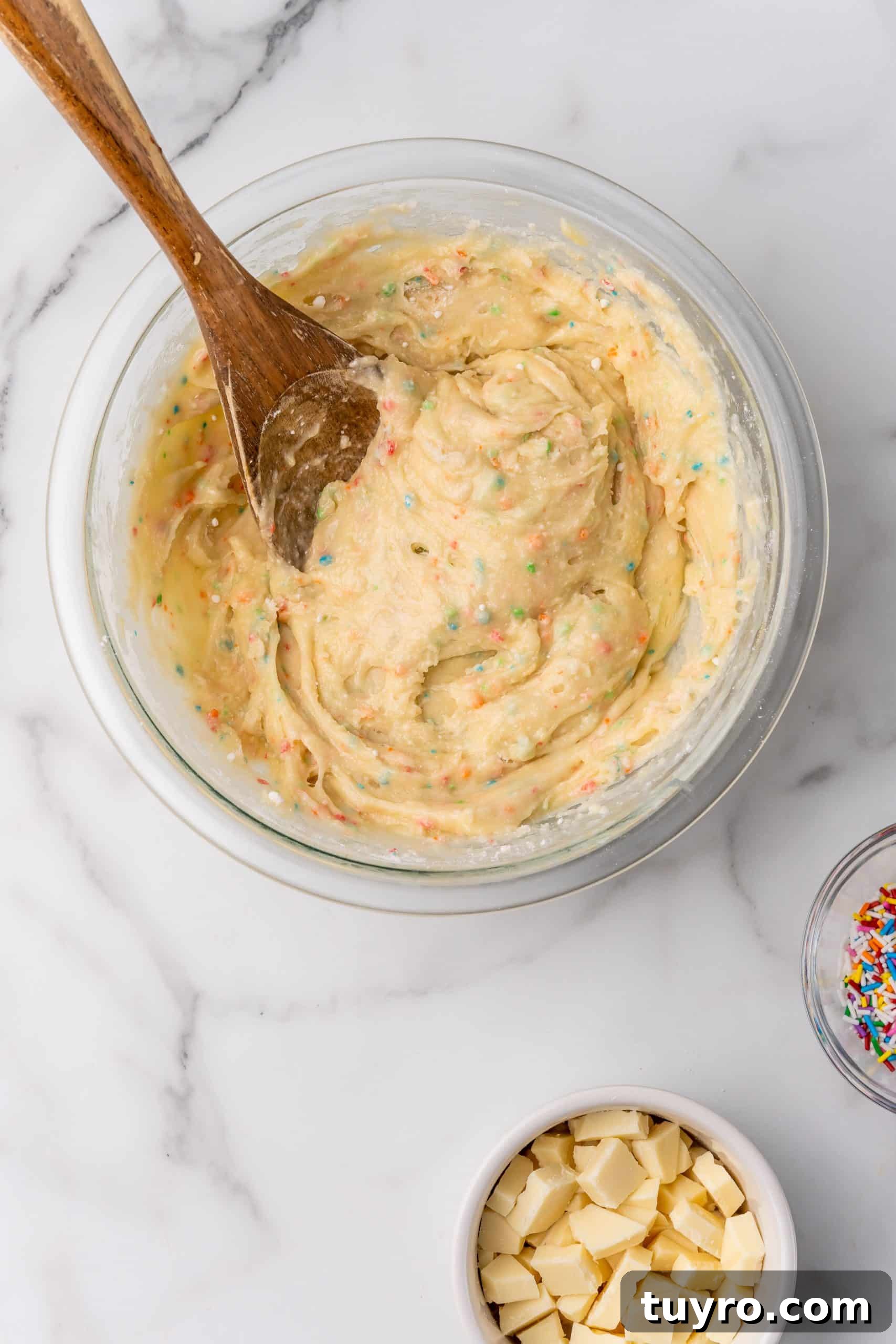Birthday Cake Blondies Recipe with Sprinkles and Frosting 6 funfetti cake mix batter in a glass mixing bowl
