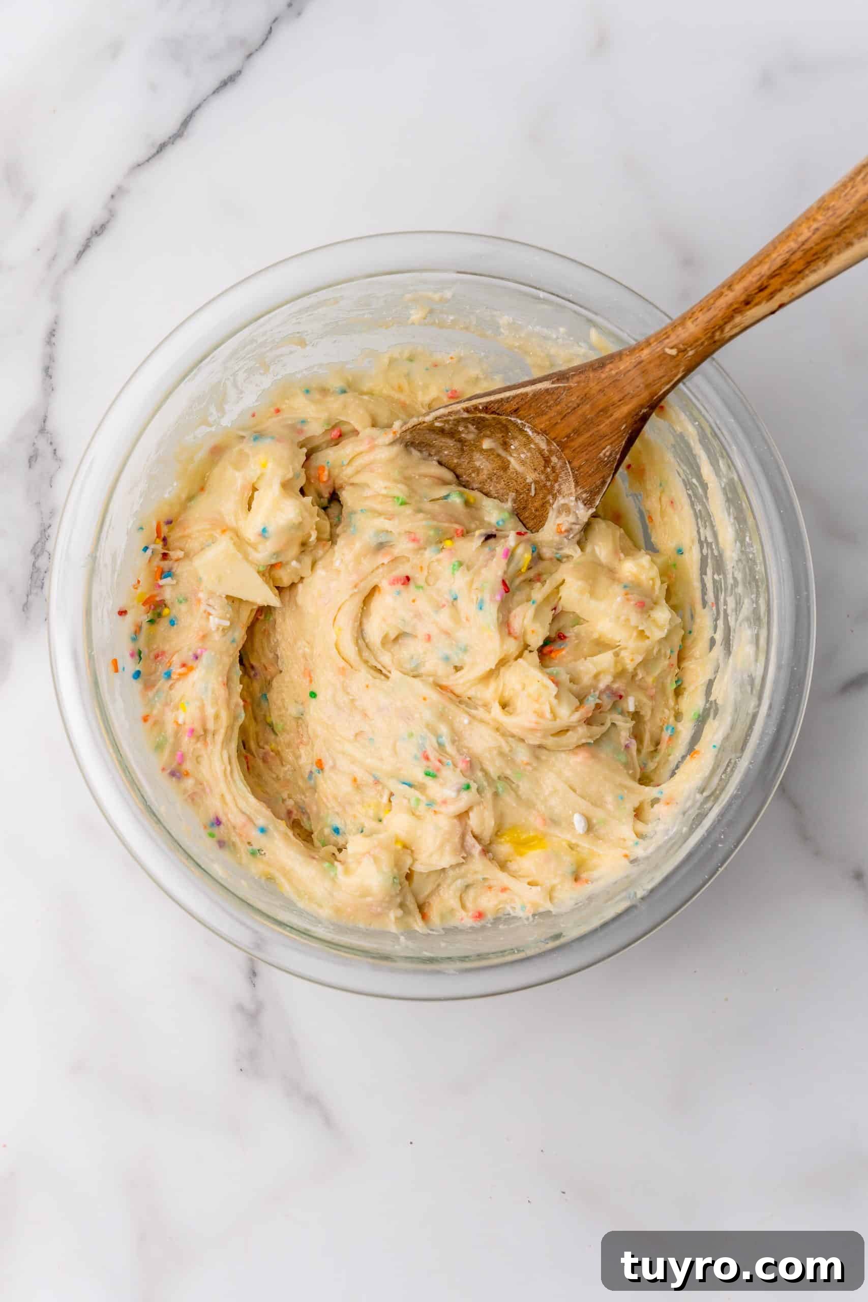 Birthday Cake Blondies Recipe with Sprinkles and Frosting 8 birthday cake blondie batter in a glass mixing bowl
