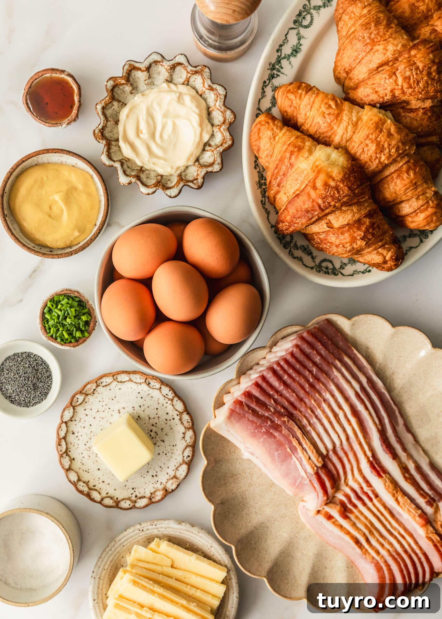 Sheet Pan Bacon, Egg & Cheese Croissant Sandwiches for Brunch 3 Plates with croissants, eggs, bacon, cheddar, chives, Dijon mustard, mayo, and poppy seeds.
