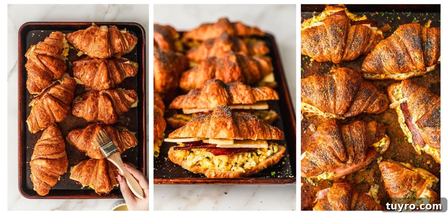 Sheet Pan Bacon, Egg & Cheese Croissant Sandwiches for Brunch 8 A hand brushing croissant sandwiches with butter before baking.