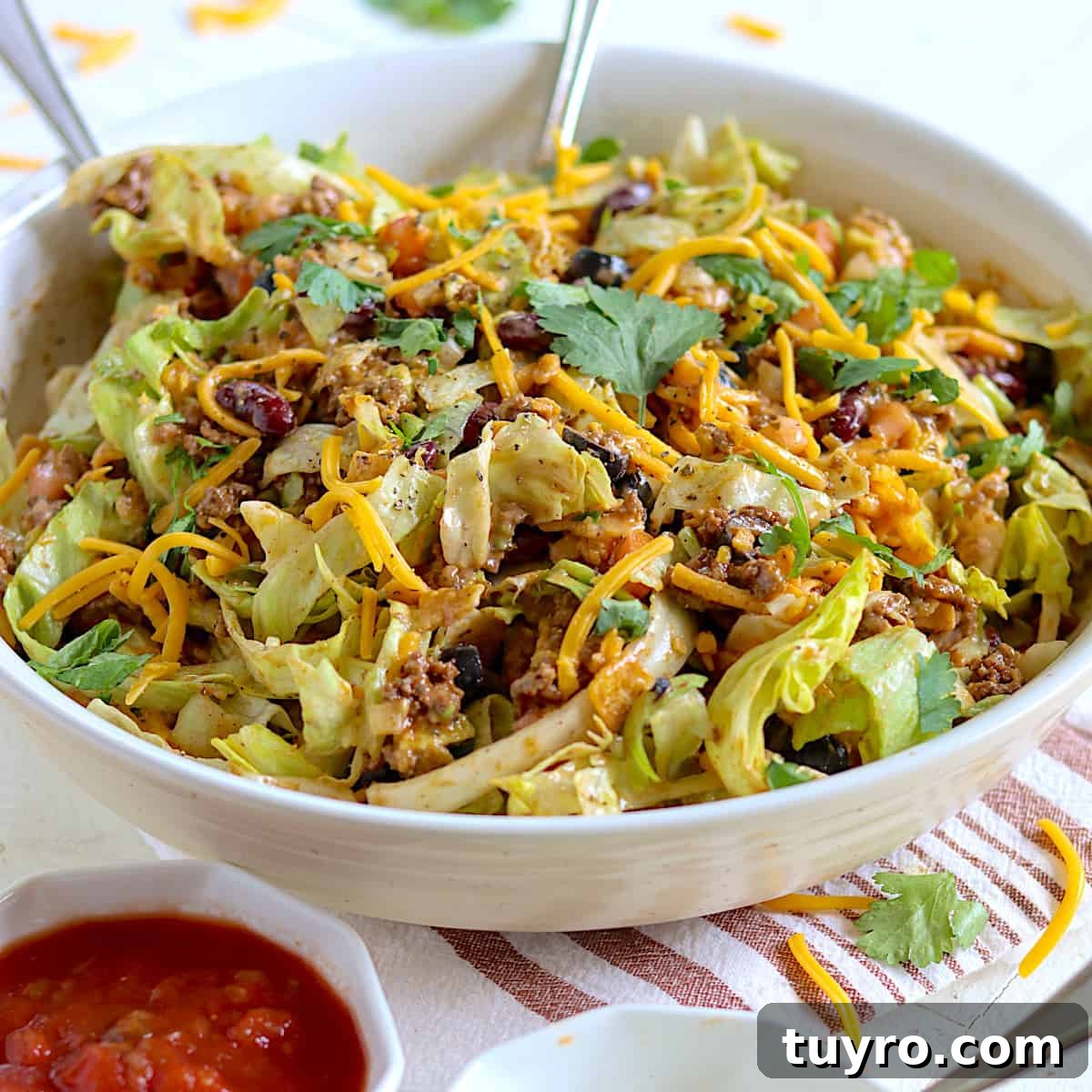 30 Taco Tuesday Ideas for a Craveworthy Dinner 9 Taco salad in a white bowl with fresh cilantro and salsa.