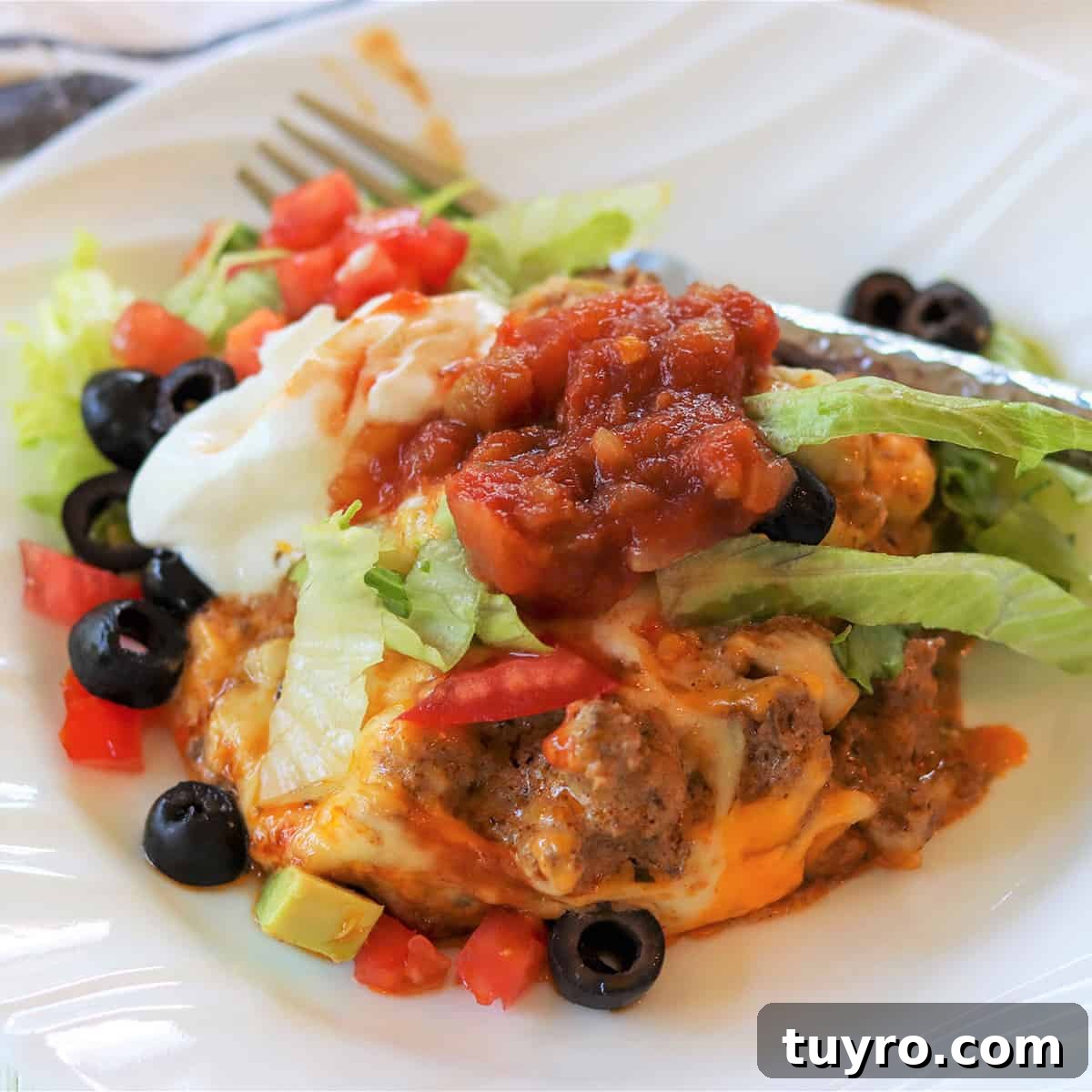 30 Taco Tuesday Ideas for a Craveworthy Dinner 10 Square image of the zucchini ground beef taco casserole on a white plate
