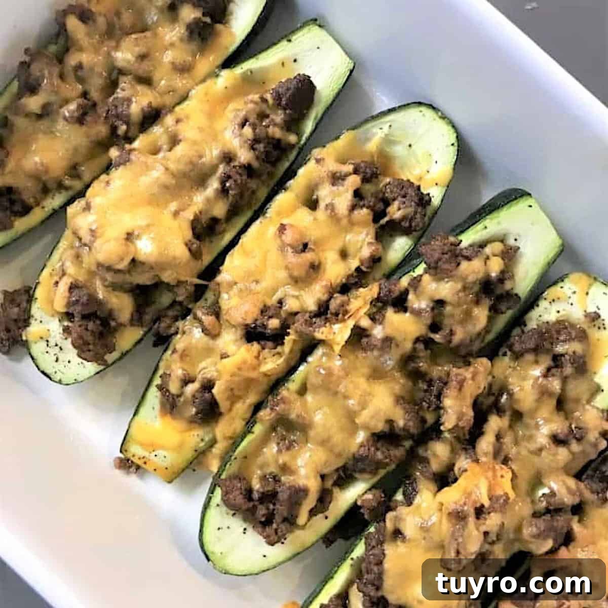 30 Taco Tuesday Ideas for a Craveworthy Dinner 11 Baked stuffed zucchini taco boats in a white rectangle baking dish.