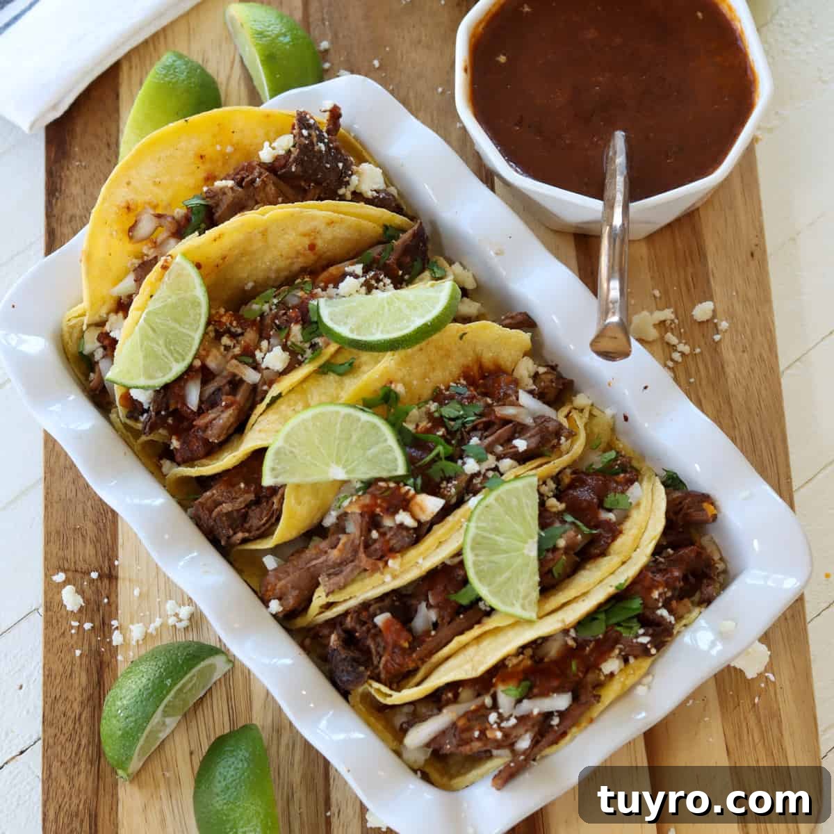 30 Taco Tuesday Ideas for a Craveworthy Dinner 17 birria taco served on a white rectangular platter.