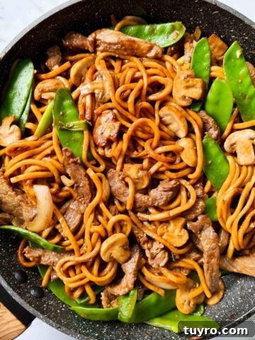 Noodle stir fry in a black pan