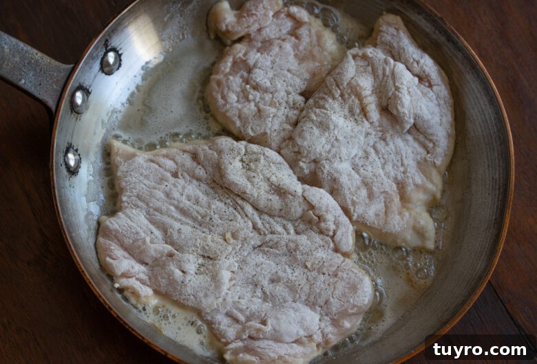 Classic Chicken Marsala Recipe with Mushroom Wine Sauce 7 Floured chicken cutlets placed in a skillet