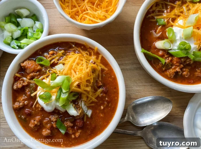 How to Make Chili: Stovetop, Crockpot, and Instant Pot 3 chili in bowls above with toppings