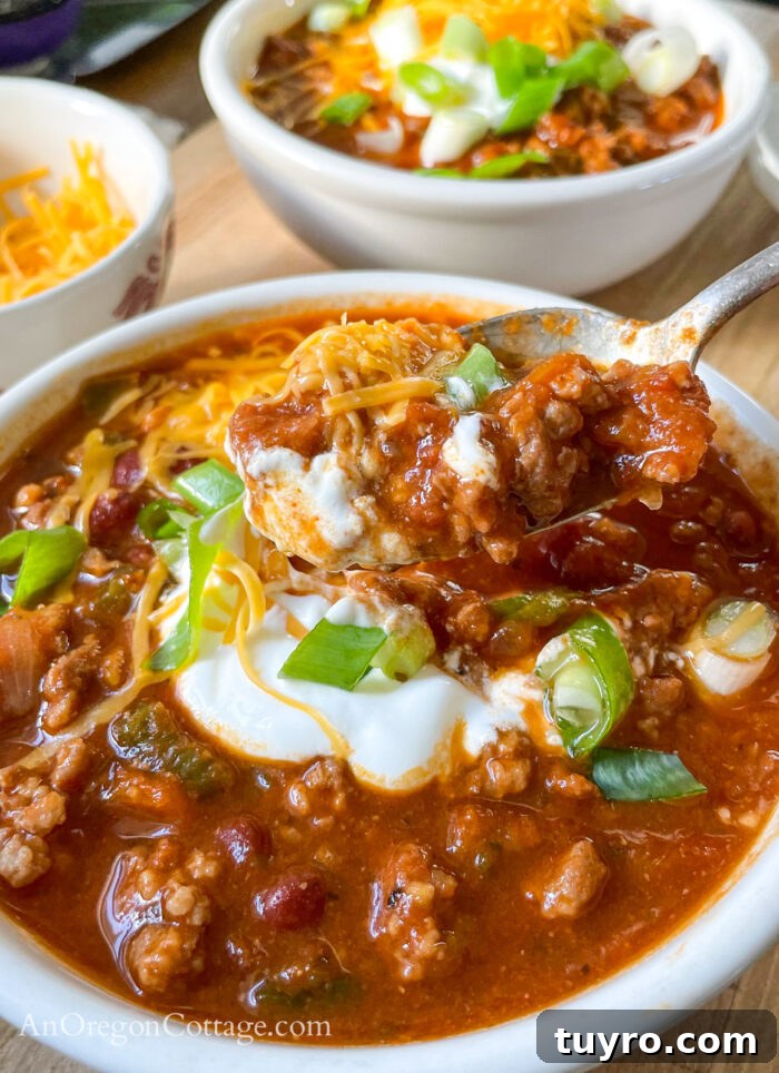 How to Make Chili: Stovetop, Crockpot, and Instant Pot 8 eating chili with toppings on spoon