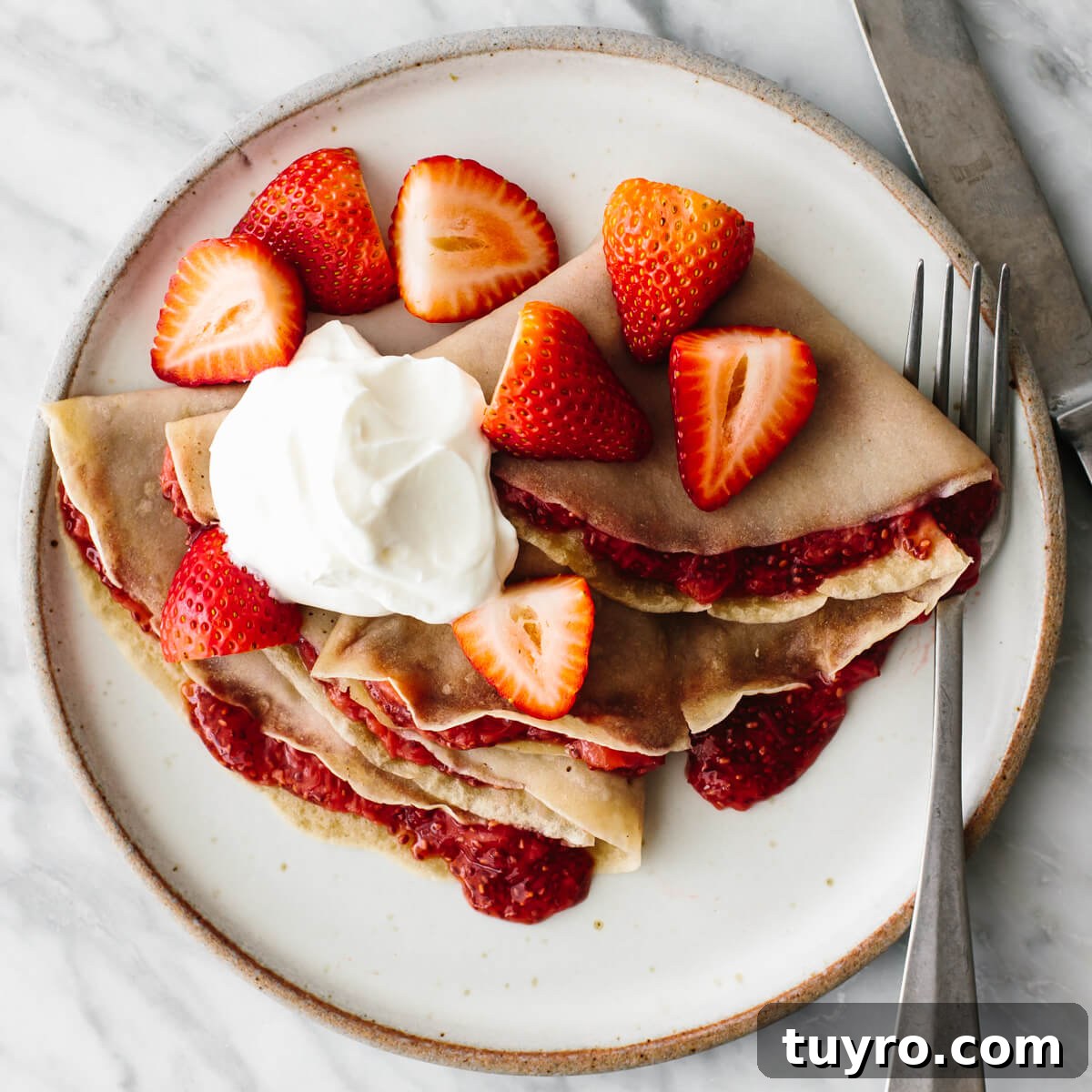 Strawberry crepes for budget meal prep Strawberry crepes on a plate for a budget meal prep