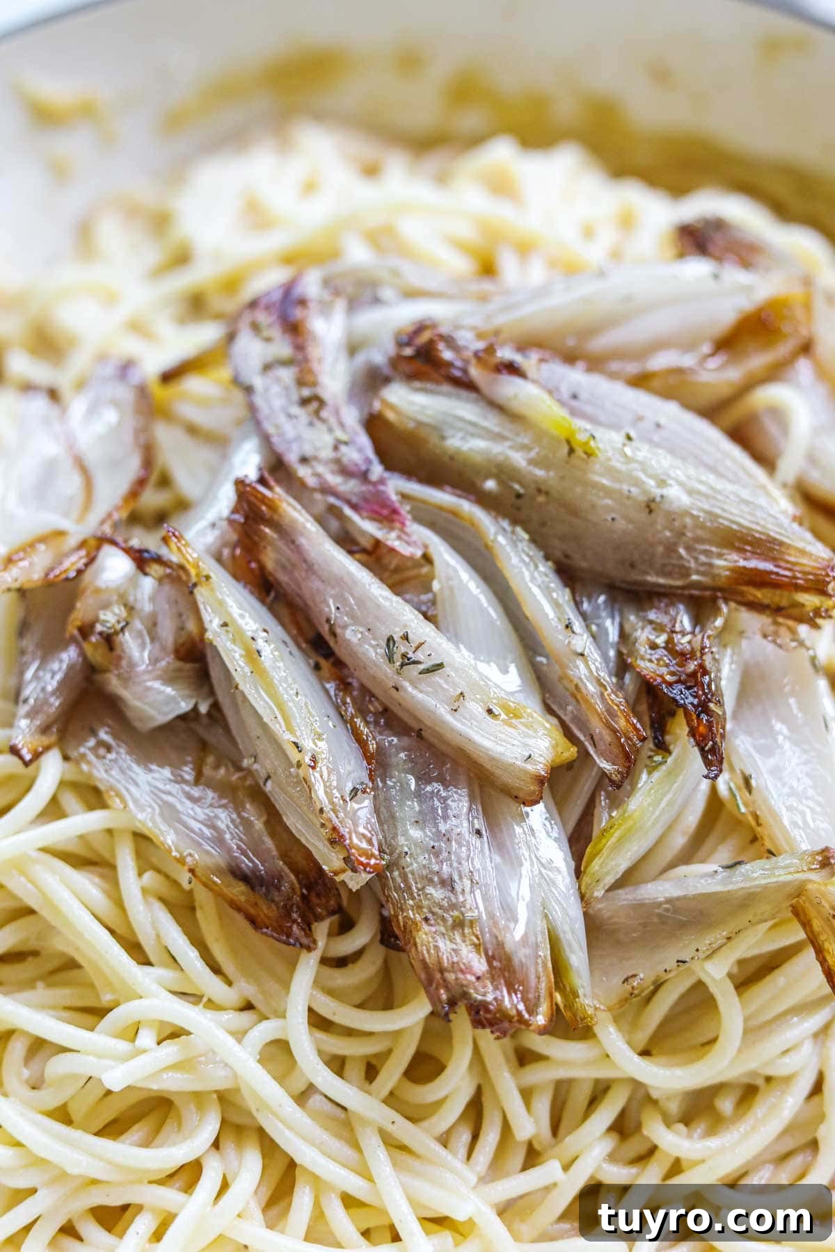 Crispy Roasted Shallots with Balsamic Glaze 5 Roasted caramelized shallots with herbs on top of pasta.