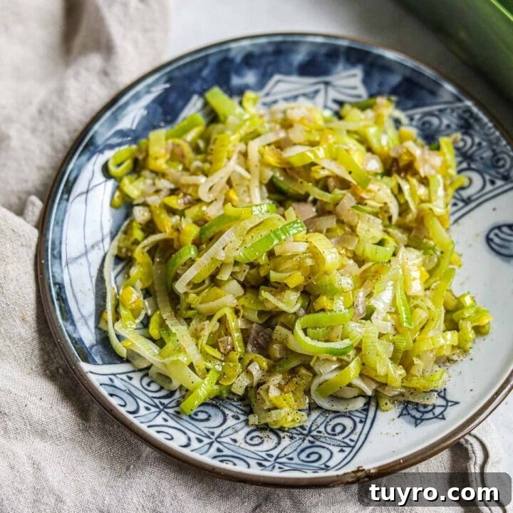 Sautéed buttered leeks with shallots on a plate.