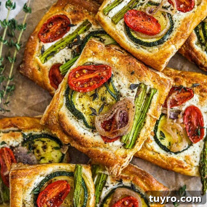 Puff pastry vegetable tarts with herbed goat cheese, cherry tomatoes, asparagus, shallots, and zucchini.
