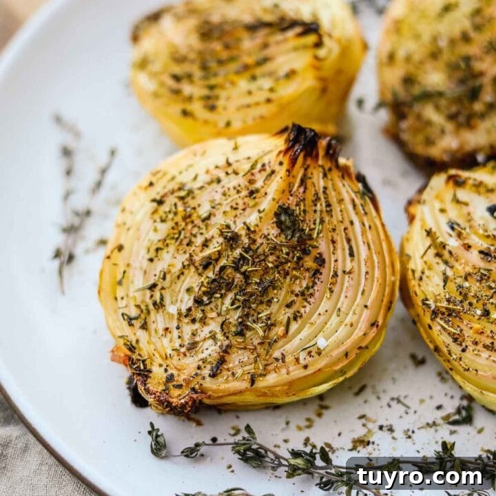 Oven roasted onions with herbs baked and served on a Heath Ceramics platter.
