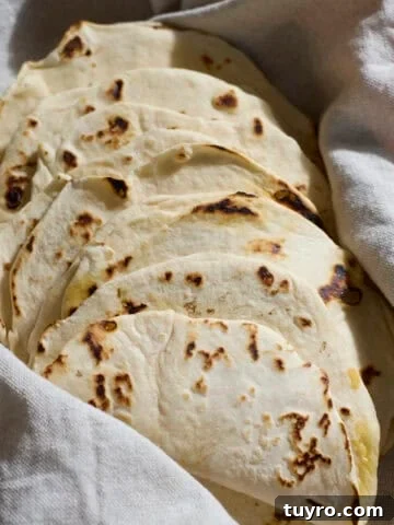 Sourdough Discard Tortillas wrapped in a kitchen towel.