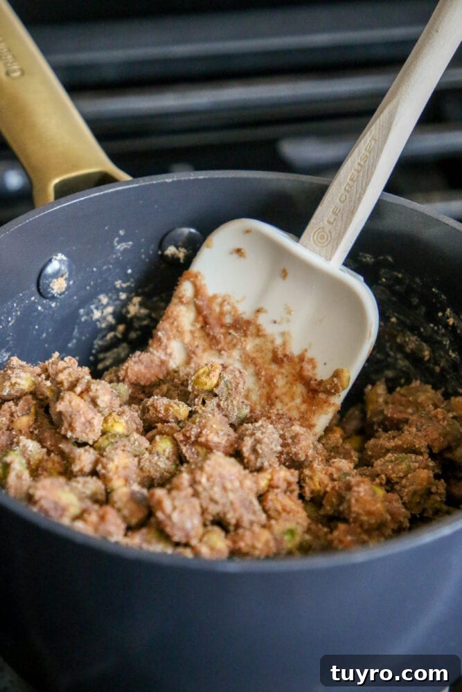 Sweet Candied Pistachios Recipe for Snacks & Gifts 8 picture of pistachios being stirred into candy mixture