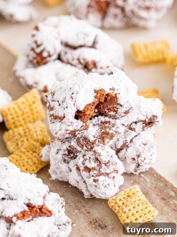 Sweet Candied Pistachios Recipe for Snacks & Gifts 12 picture of muddy buddy cookies stacked on a wood cutting board