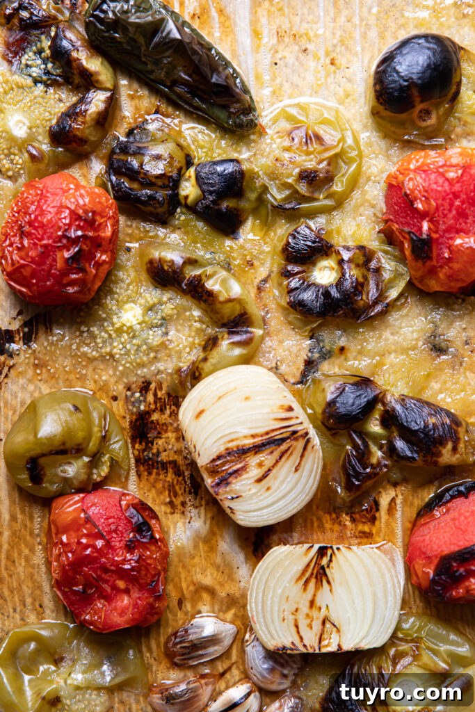 Smoky Roasted Tomatillo Salsa Verde Recipe 8 roasted vegetables on a sheet pan.