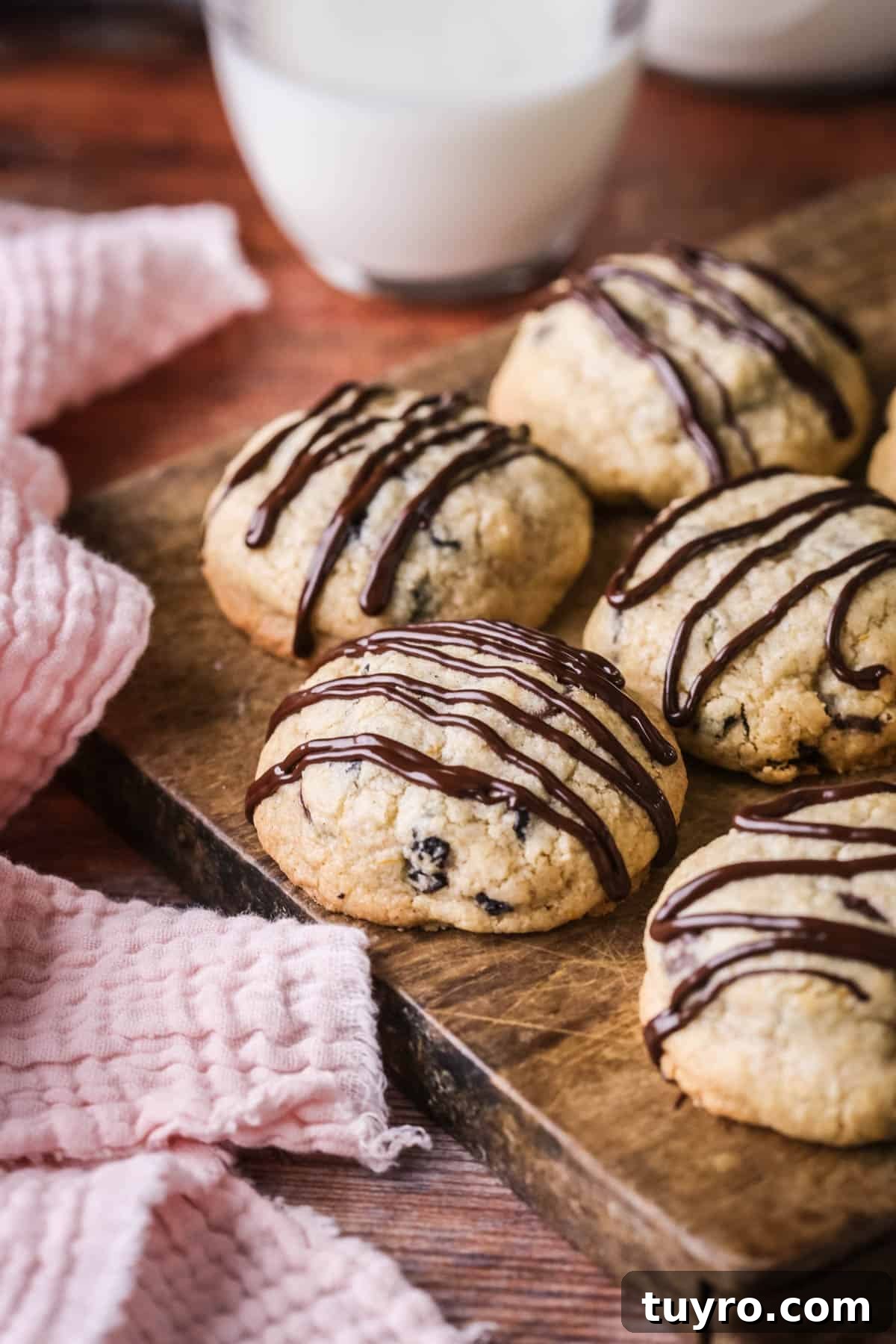 Gluten-Free Easter Cookie Recipes for Spring Baking 2 Easter Cookies packed with marzipan, currants, spice and chocolate resting on a wooden board.