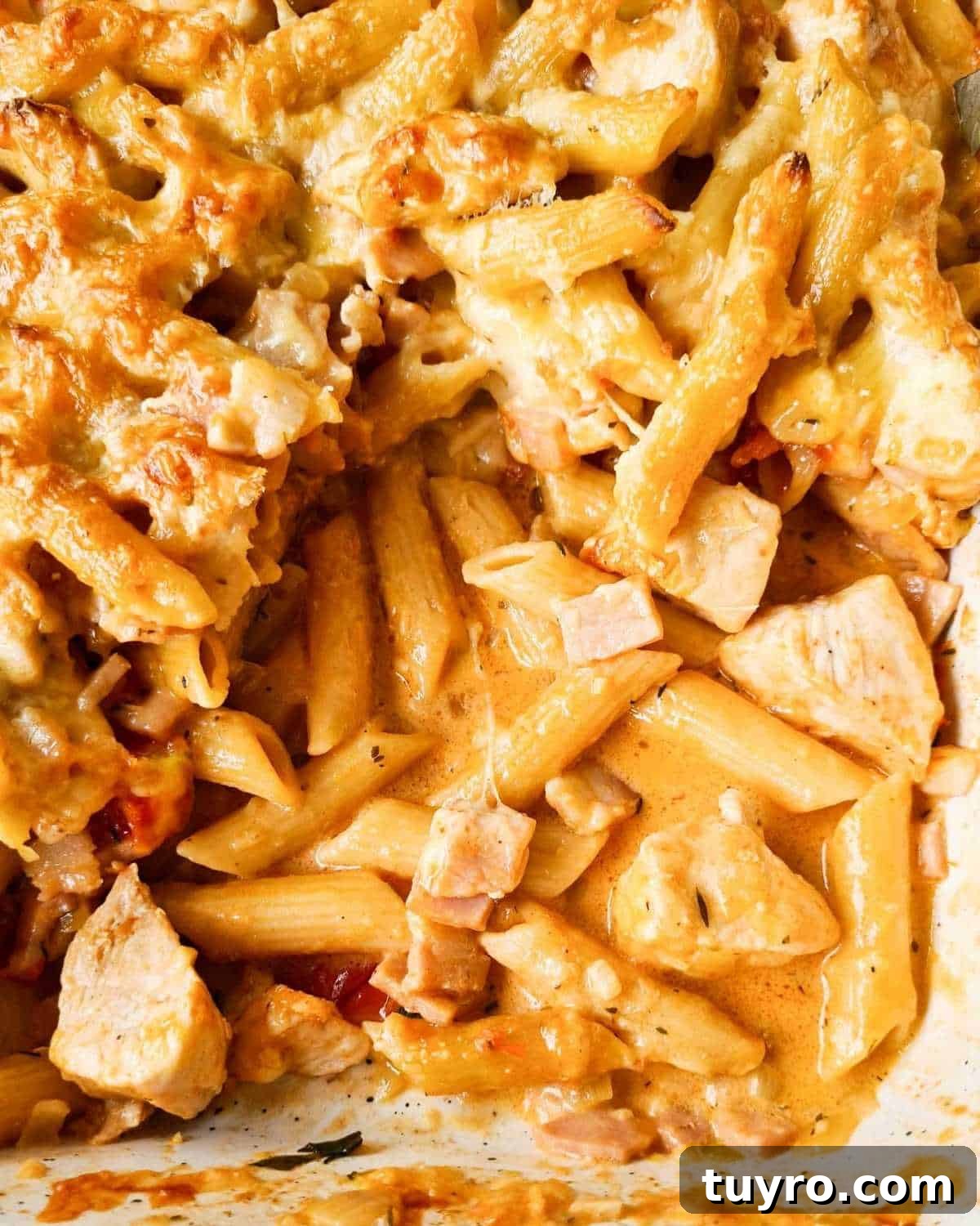 Creamy Chicken & Bacon Pasta Bake Recipe for Weeknight Dinners 2 Close up of a tray of creamy pasta bake with a few scoops taken out of the tray