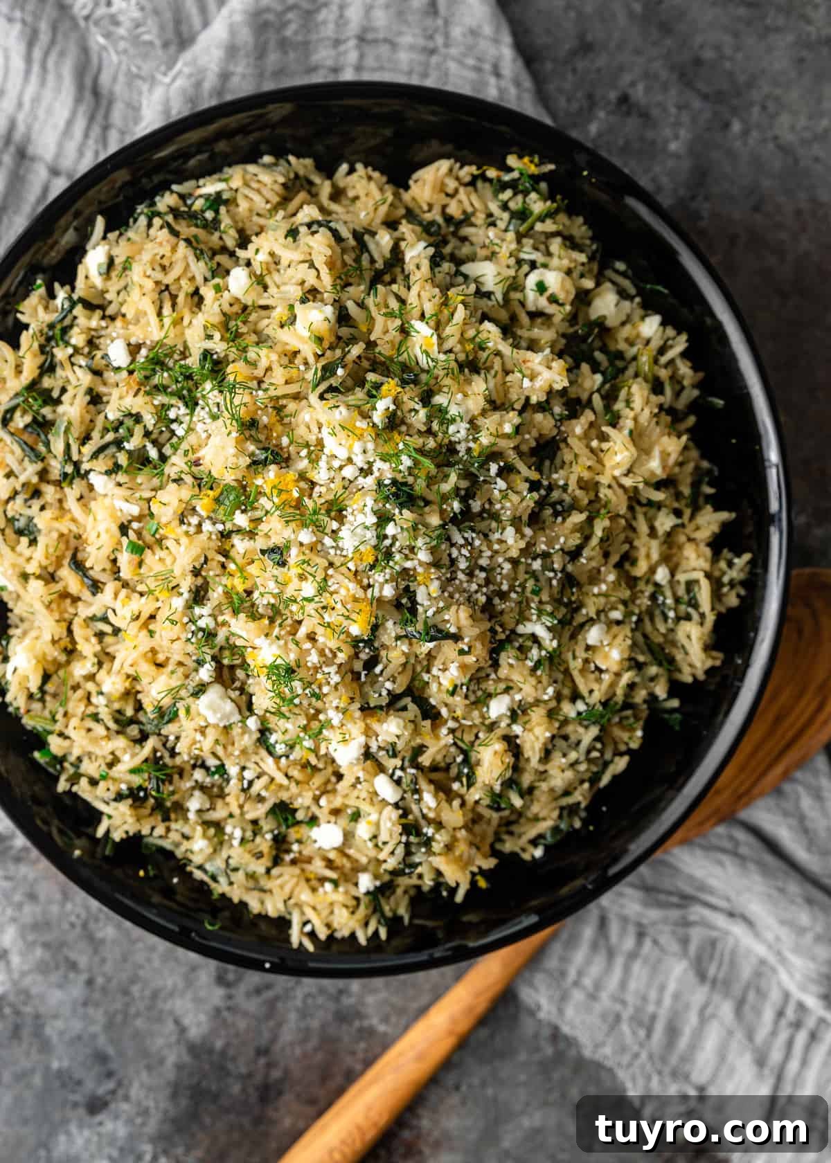 overhead image: bowl of Mediterranean rice with Greek seasonings, spinach and feta cheese