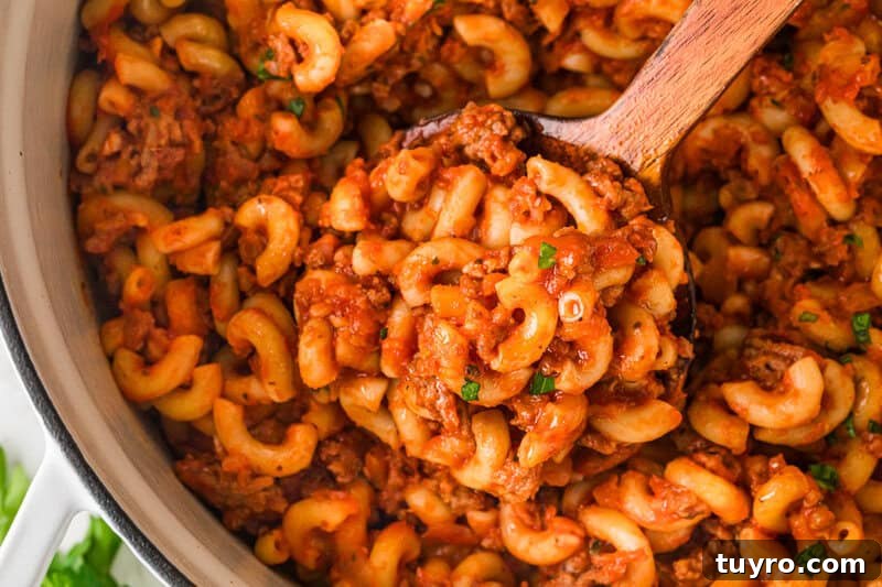 Homemade Beefaroni: Savory One-Pot Pasta Recipe 4 closeup of serving the Beefaroni out of the pot.