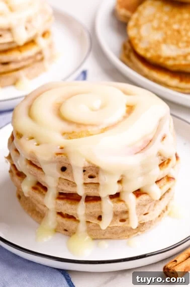 Fluffy Homemade Strawberry Waffles Recipe 10 A stack of cinnamon pancakes topped with cream cheese glaze.