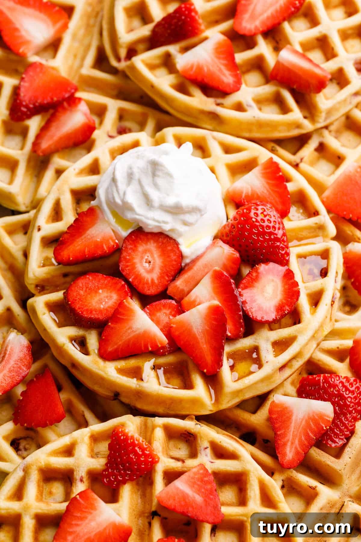 Fluffy Homemade Strawberry Waffles Recipe 3 close up image of a pile of strawberry waffles.