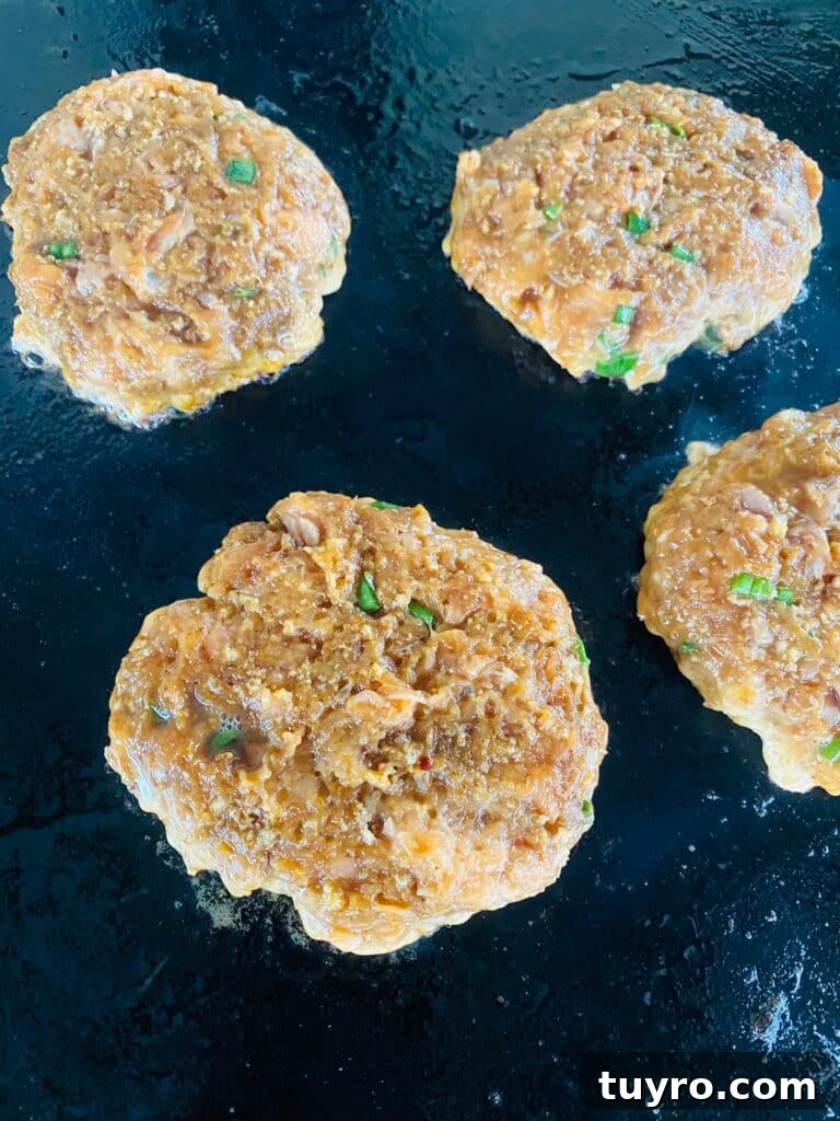 salmon burgers on the griddle before cooking
