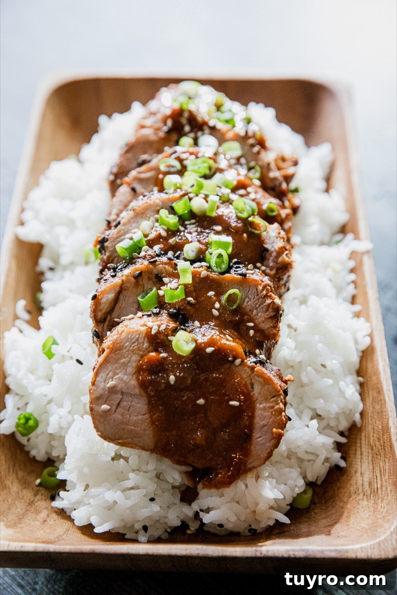 Sous-Vide Korean Pork Tenderloin with Gochujang Glaze 7 Plated tenderloin with garnish