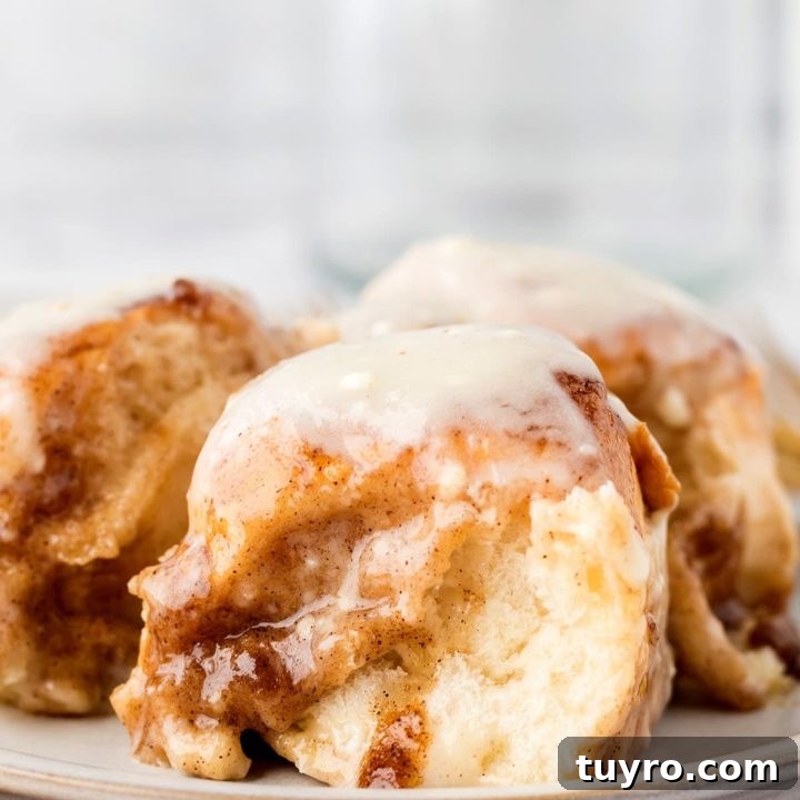 Gooey homemade cinnamon rolls with icing on a plate