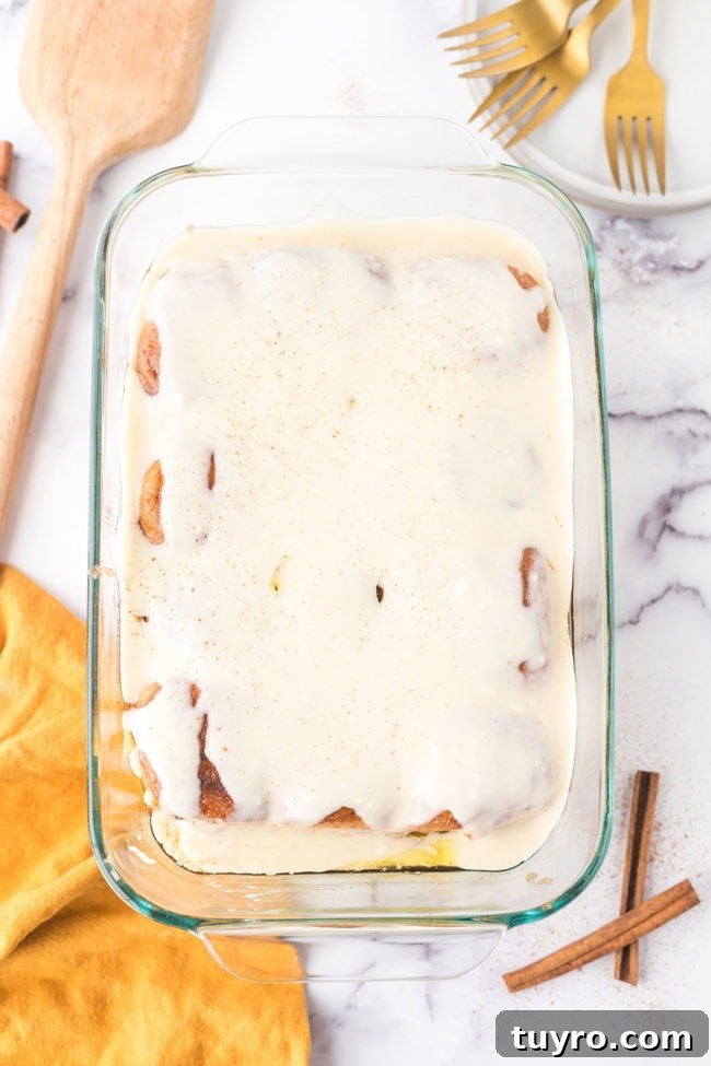 30-Minute Homemade Cinnamon Rolls 5 homemade cinnamon rolls in a baking dish covered in cream cheese frosting