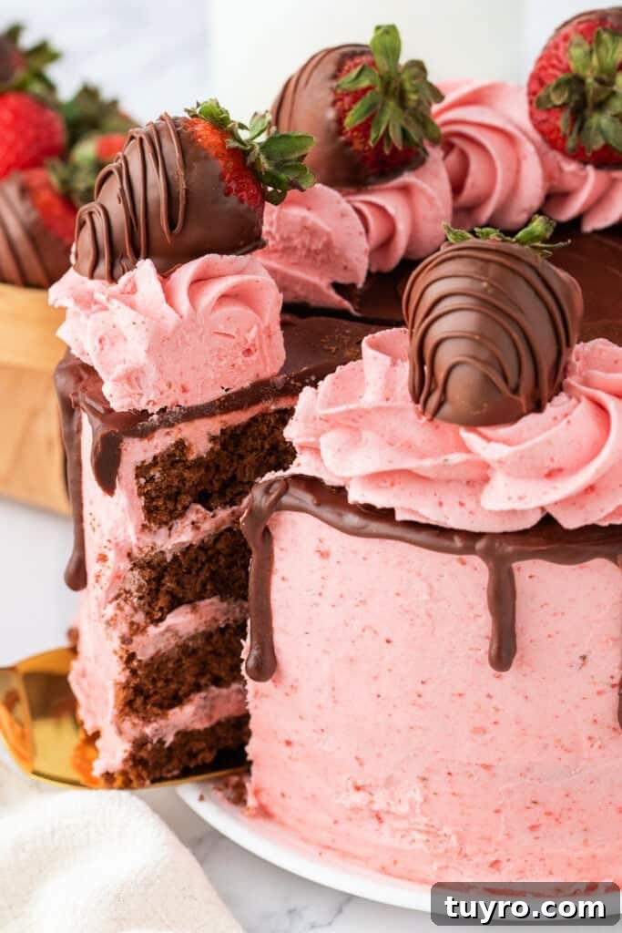 Chocolate Strawberry Cake with Rich Ganache 9 Sliced chocolate strawberry cake with pink frosting and chocolate ganache, topped with chocolate-covered strawberries.