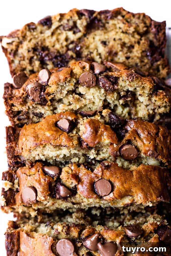 Overhead view of a loaf of banana bread with chocolate chips that has been sliced into thick slices.