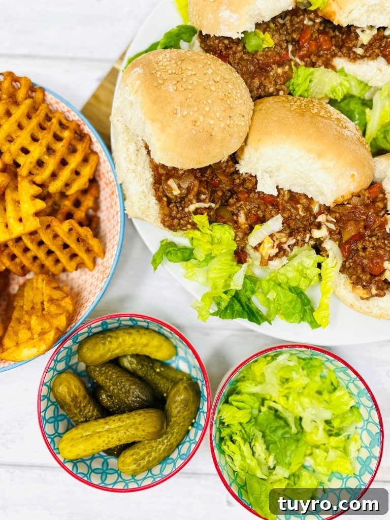 4-Week Weekly Meal Plan: Simple Dinners and Grocery List 6 homemade sloppy joes recipe served on soft white dinner rolls with lettuce. Waffle fries, lettuce and gherkins on the side in bowls