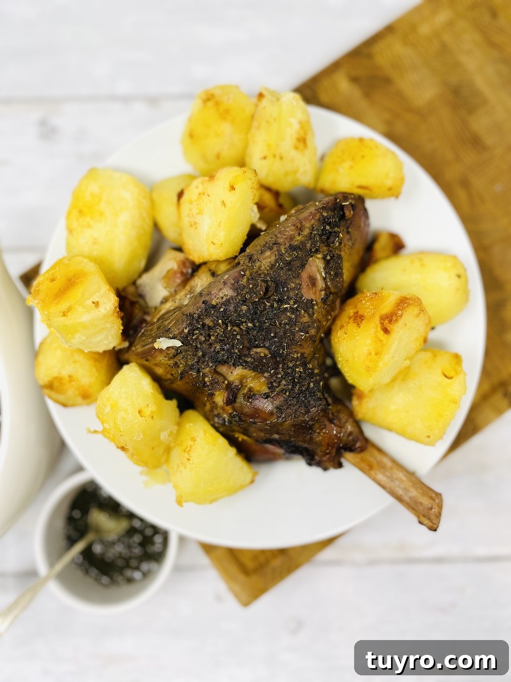 4-Week Weekly Meal Plan: Simple Dinners and Grocery List 9 slow cooker lamb on a platter with roasted potatoes, mint sauce and gravy