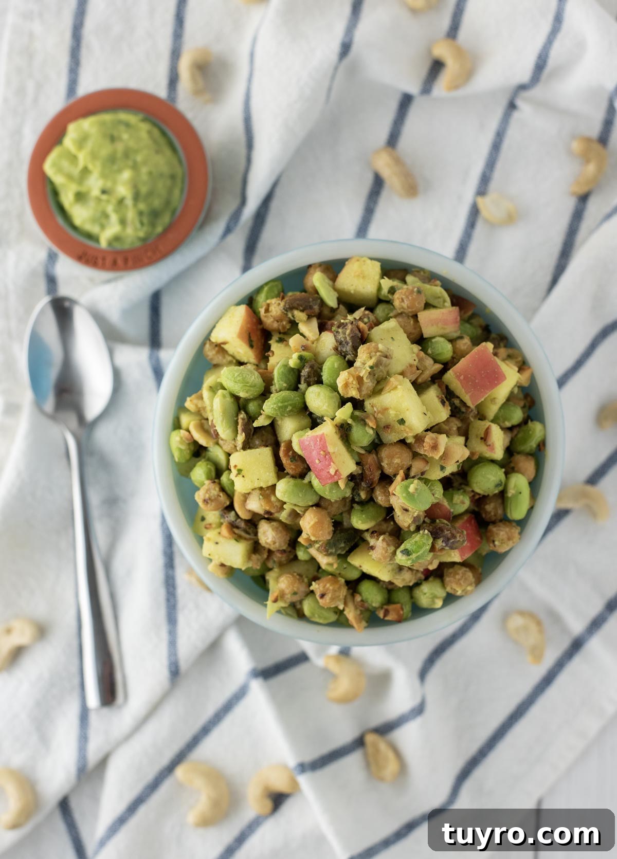 Edamame Salad with Sesame Ginger Dressing 3 overhead shot of edamame salad in blue bowl with side of avocado dressing