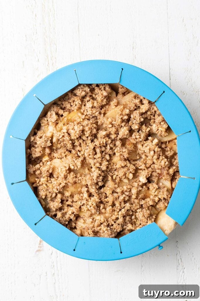 Flaky Almond Flour Pie Crust Recipe for Perfect Pastries 4 A pie made with an almond flour crust, with a silicone pie shield around the edges to prevent over browning or burning.