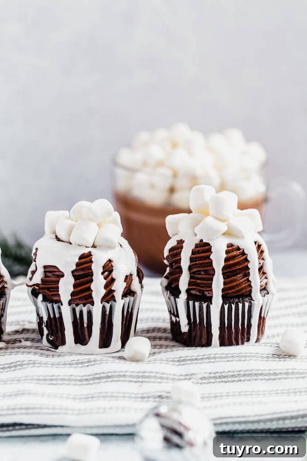 Cupcakes with hot chocolate in background hot chocolate cupcakes on a dish towel with a mug of hot chocolate in the background