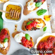 Tomato Confit & Burrata Crostini with a spicy sweet drizzle of chili honey