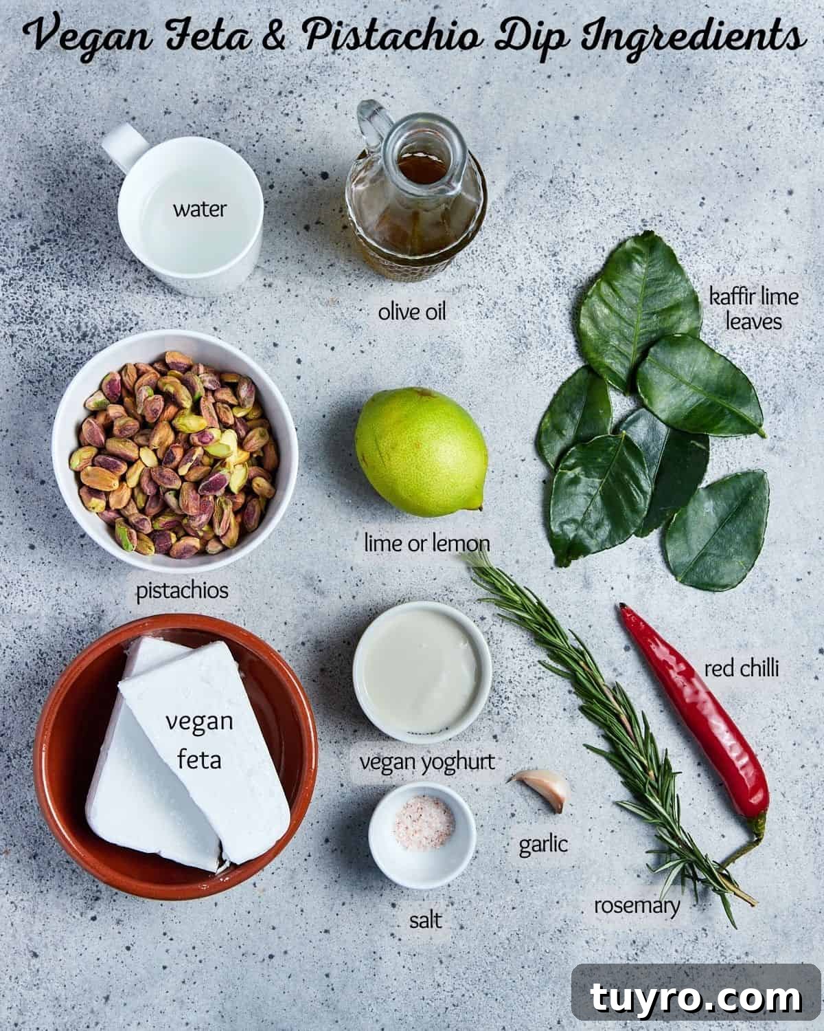 Vegan Whipped Feta Dip with Pistachios Lime Leaves and Rosemary 3 Labelled photo showing the ingredients for making vegan whipped feta and pistachio dip, all set out on a grey background.