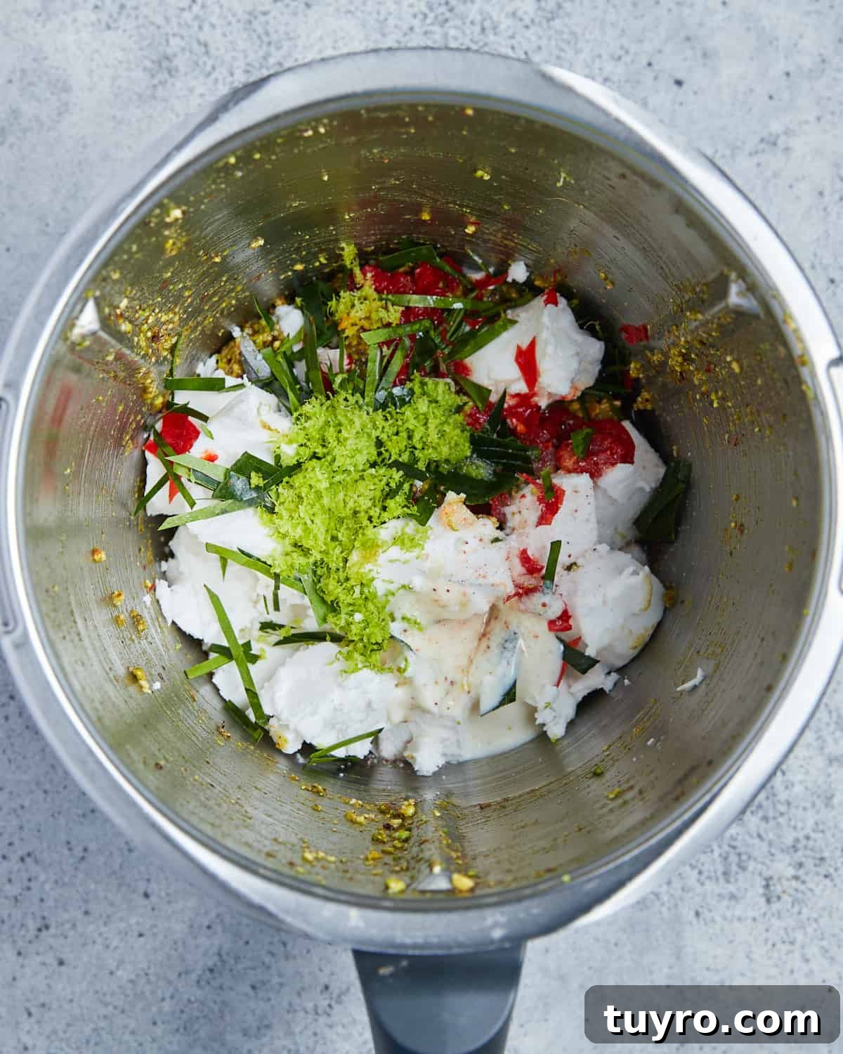 Vegan Whipped Feta Dip with Pistachios Lime Leaves and Rosemary 6 Overhead photo of the food processor filled with all of the ingredients to make this vegan feta dip.