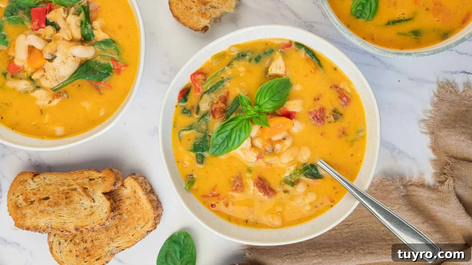 Creamy Tuscan White Bean Soup with Chicken in a bowl.