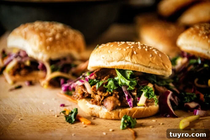 Sliders filled with hoisin pulled pork topped with spicy kale slaw.